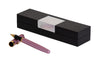 Pink pen with gold-tone trim lying beside a closed black gift box