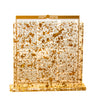 Clear Lucite bencher holder filled with gold flakes, Birkat Hamazon benchers visible inside