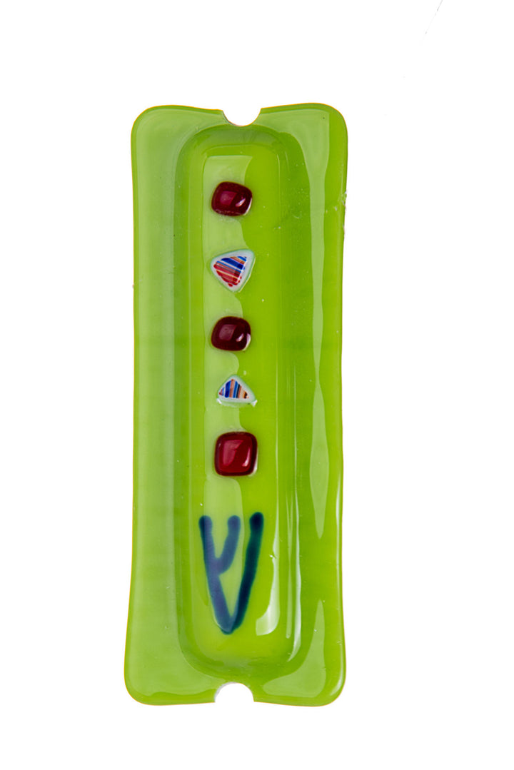Lime green glass mezuzah with a column of red dots and patterned chips above a blue Shin