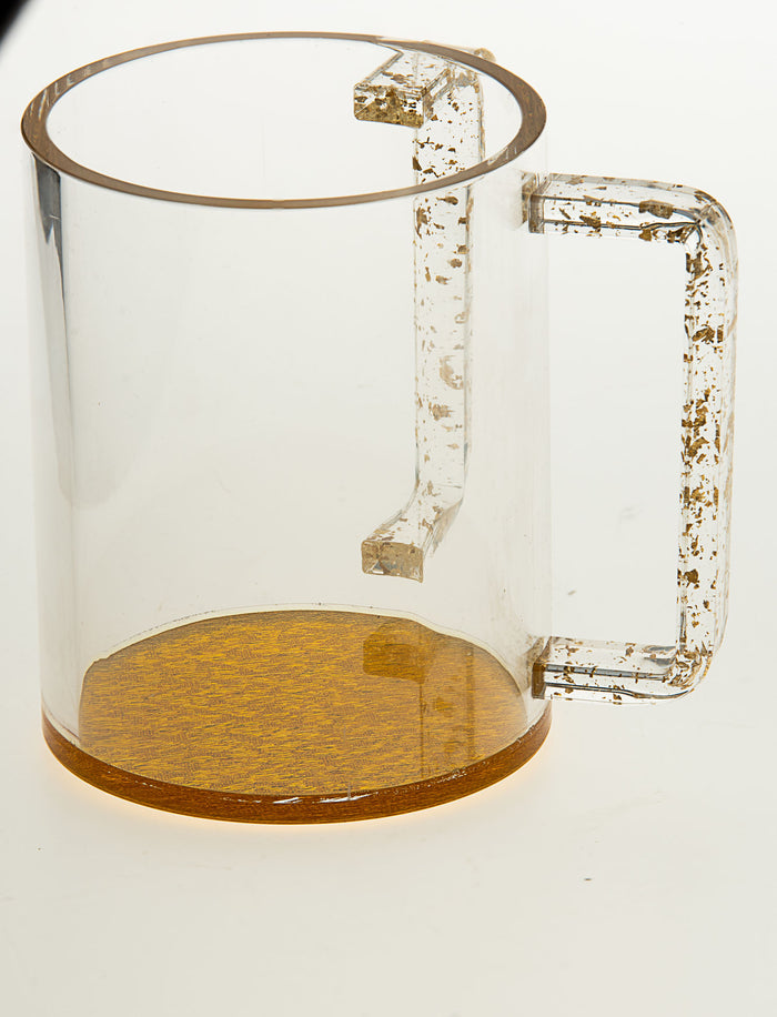 Clear Lucite wash cup with gold-tone rim, gold-flecked handles and a solid gold-colored base