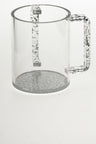 Clear Lucite wash cup with silver-flecked handles and a silver speckled base
