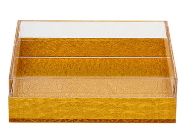 Square napkin holder with gold-tone textured base and clear Lucite sides