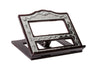 Silver plated book holder with embossed scroll frame on a dark wood stand, open center window
