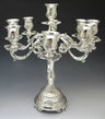 Ornate silver plated 9 branch candelabra with scrolled arms and fluted footed base
