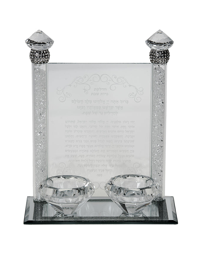 Crystal tea light candlestick with two faceted cups before an etched Hebrew blessing panel on a mirrored base