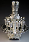 Silver plated eight-cup wine fountain with grape clusters and stemmed goblets on a round tray