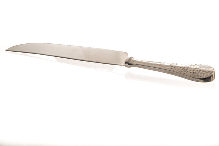 Stainless steel challah knife with a long smooth blade and a hammered handle on white