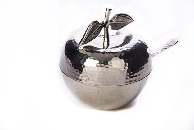 Hammered stainless steel apple-shaped honey dish with a stem and leaf lid and a spoon handle showing