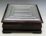 Square dark wood tea box with a sterling silver lattice-pattern lid and a footed base
