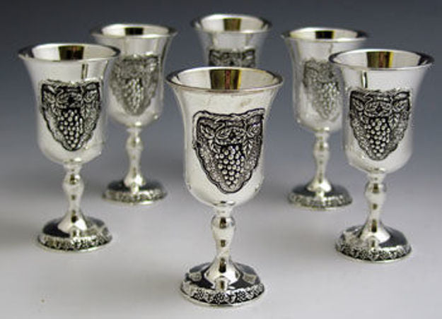 Six silver plated stemmed liquor goblets, each with a raised grape cluster panel