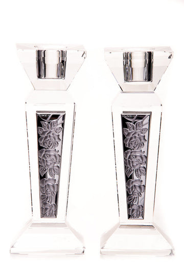 Clear crystal candlesticks with dark inset panels showing a raised rose and leaf pattern