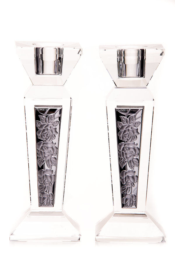 Clear crystal candlesticks with dark inset panels showing a raised rose and leaf pattern