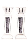 Clear crystal candlesticks with dark inset panels showing a raised rose and leaf pattern