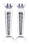 Pair of tapered crystal candlesticks with silver rose panels running down each column