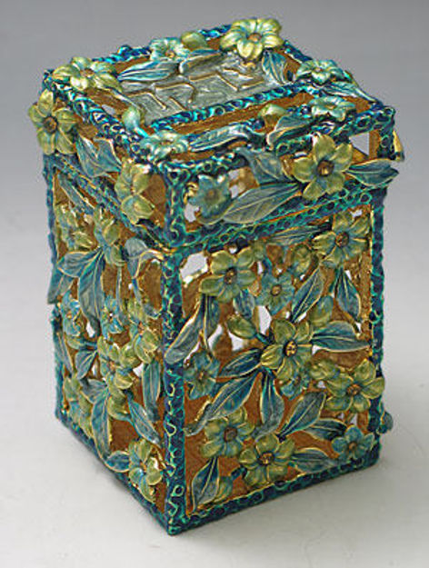 Jeweled tzedakah box covered in yellow-green flowers and blue leaves over gold-tone openwork