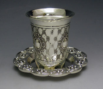 Small silver plated kiddush cup on a slender stem resting on its round saucer