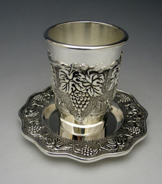 Silver plated Kiddush cup with raised grape clusters on a scalloped tray with a grapevine border