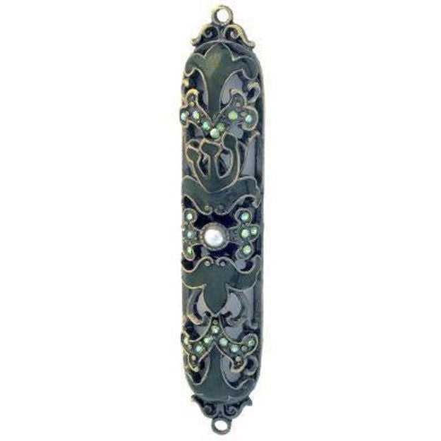 Dark jeweled mezuzah case with bronze-tone scroll openwork, small pale stones and a pearl-like center