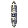 Jeweled mezuzah case with ivory scrolls on black, pastel stones and a pearl-like center in a bronze-tone frame