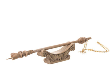 Cempaka wood yad Torah pointer resting on its carved wooden stand with a gold plated chain attached