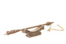 Cempaka wood yad Torah pointer resting on its carved wooden stand with a gold plated chain attached