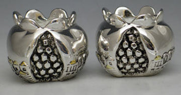 Two silver-tone pomegranate-shaped tea light holders with Jerusalem relief and open grid centers