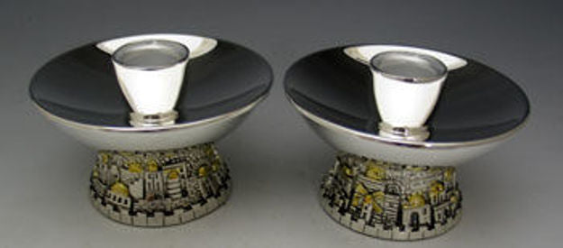 Two low candlesticks with wide polished bowls on bases shaped as the Jerusalem skyline with gold domes