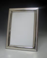 Small 4x6 sterling silver picture frame with polished border and beaded edge on a grey backdrop