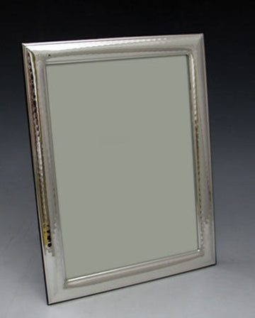Upright 5x7 sterling silver picture frame with a textured inner border, angled against a dark background