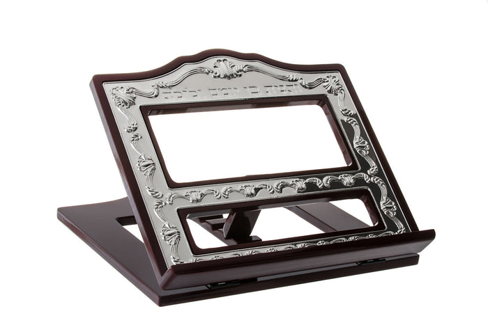 Angled dark wood book holder with ornate silver plated frame and open cut-out panels