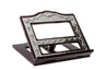 Angled dark wood book holder with ornate silver plated frame and open cut-out panels