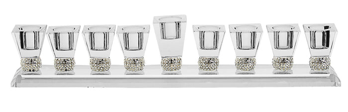 Low clear crystal menorah with square cups on sparkling stone bands and a taller center shamash