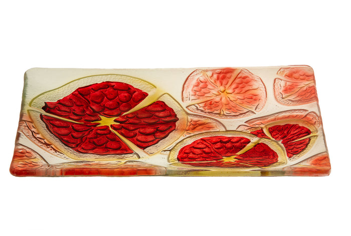 Rectangular glass platter printed with sliced red pomegranates outlined in gold-tone