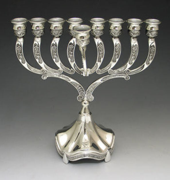 Silver plated menorah with engraved curved arms, a front shamash and a fluted bell-shaped base