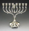 Silver plated menorah with engraved curved arms, a front shamash and a fluted bell-shaped base