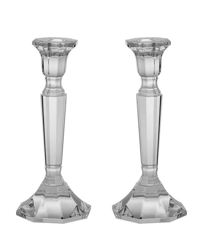 Two clear crystal candlesticks with faceted tapering stems and six-sided bases