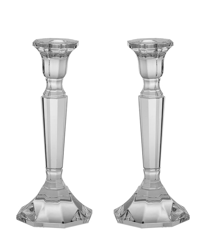 Two clear crystal candlesticks with faceted tapering stems and six-sided bases