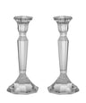 Two clear crystal candlesticks with faceted tapering stems and six-sided bases