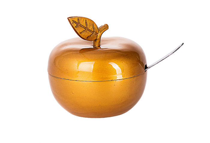 Glossy gold enamel apple-shaped honey dish with stem and leaf lid and a spoon