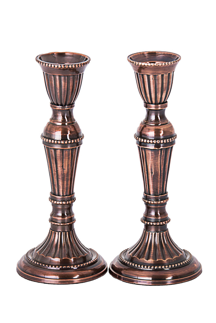 Pair of fluted bronze-tone metal candlesticks with beaded rings and round bases