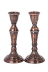 Pair of fluted bronze-tone metal candlesticks with beaded rings and round bases