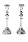 Two hammered stainless steel candlesticks with polished turned stems and domed bases