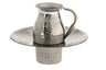 Small hammered stainless steel pitcher seated in a wide-rimmed hammered basin