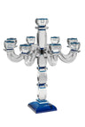 Multi-arm clear crystal candelabra with blue-rimmed candle cups on a tall column and blue base