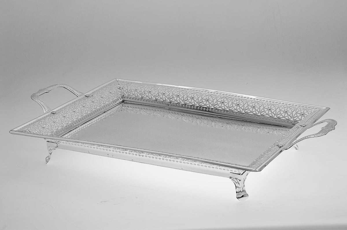 Angled view of the footed silver plated tray showing its pierced rim, shaped feet and handles