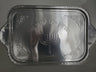 Rectangular silver foil tray embossed with Hebrew text, a menorah and scrolled corner designs