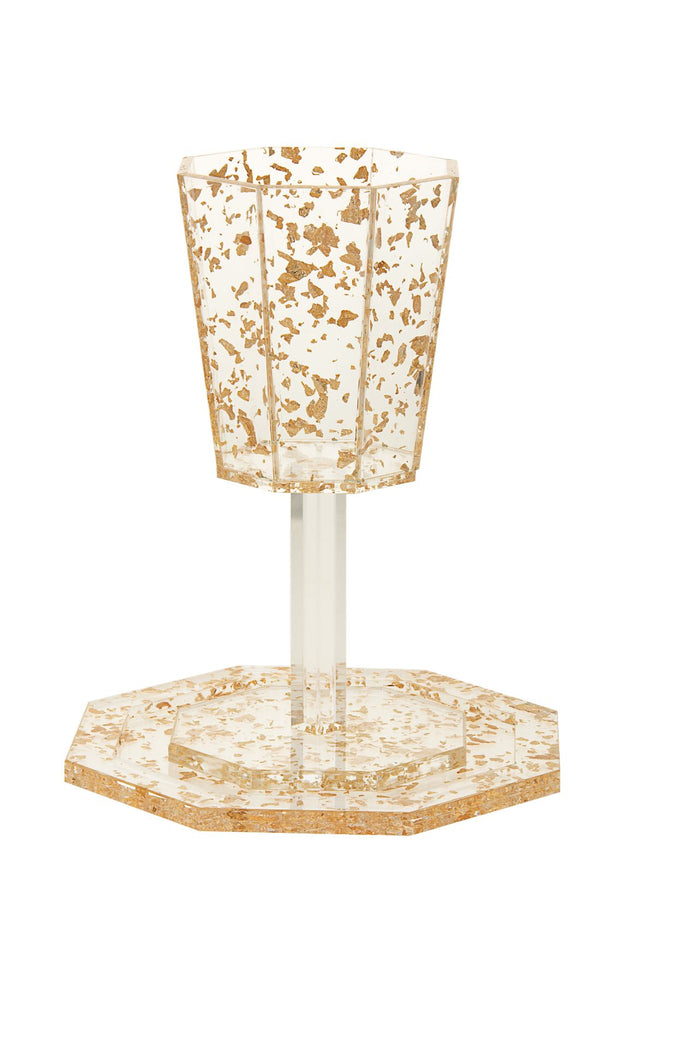 Faceted Lucite Elijah goblet with gold flakes on a clear stem, set on a matching octagonal tray