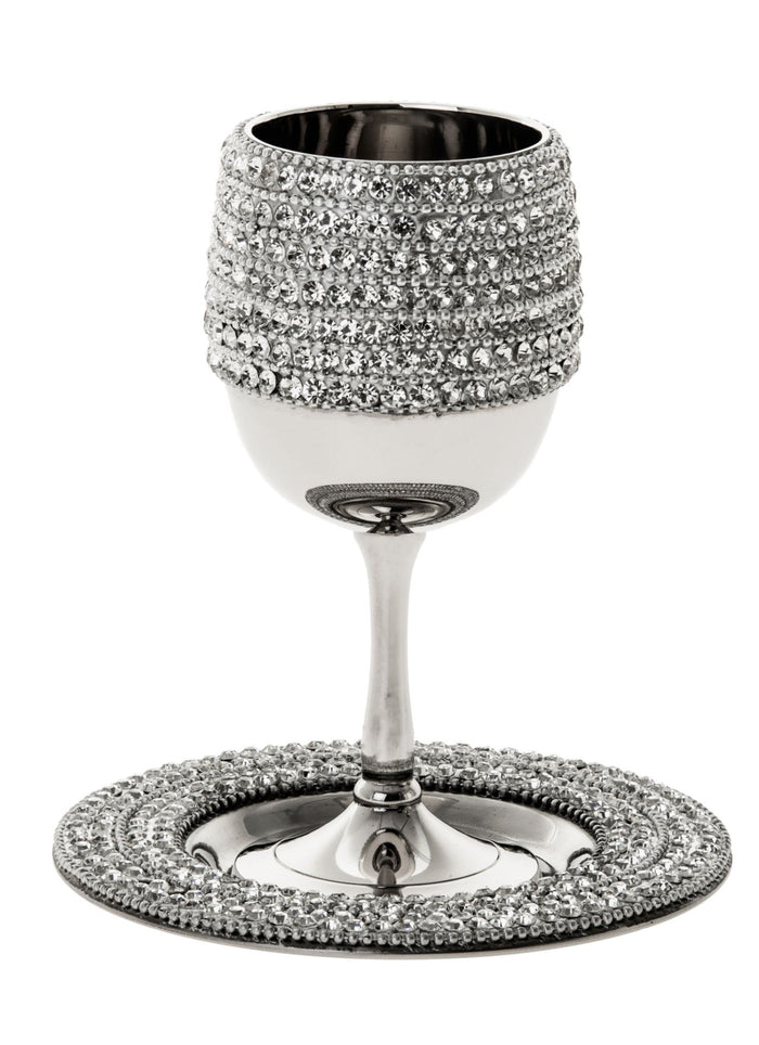 Stainless steel Kiddush cup covered in rows of clear stones on a stone-rimmed round tray