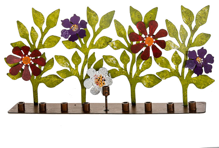 Handmade metal menorah with red, purple and silver flowers on green stems above copper-tone cups