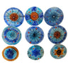 Nine assorted glass wall art discs in blue, turquoise and orange with starbursts, hamsa and Star of David